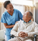 Help, support and wheelchair with nurse and old man for disability, rehabilitation or healing. Retirement, physiotherapy and healthcare with patient and black woman nursing home for medical caregiver